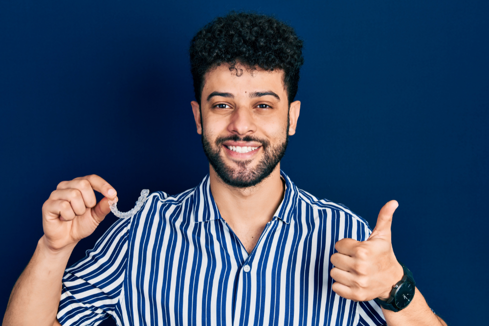 a man is wearing invisalign